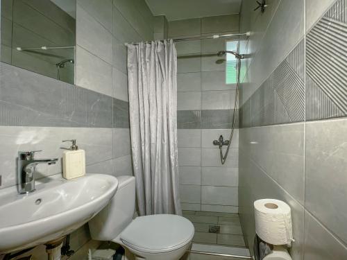 compact_bathroom_with_modern_shower_and_sink