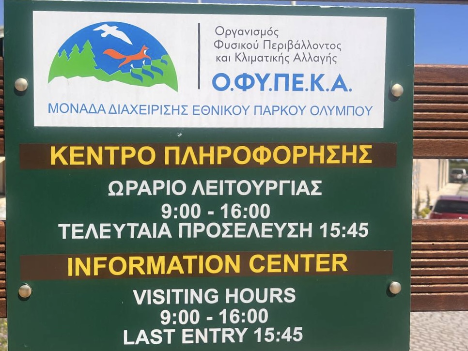 Opening hours sign at Mount Olympus National Park Information Center: 9:00–16:00, last entry 15:45